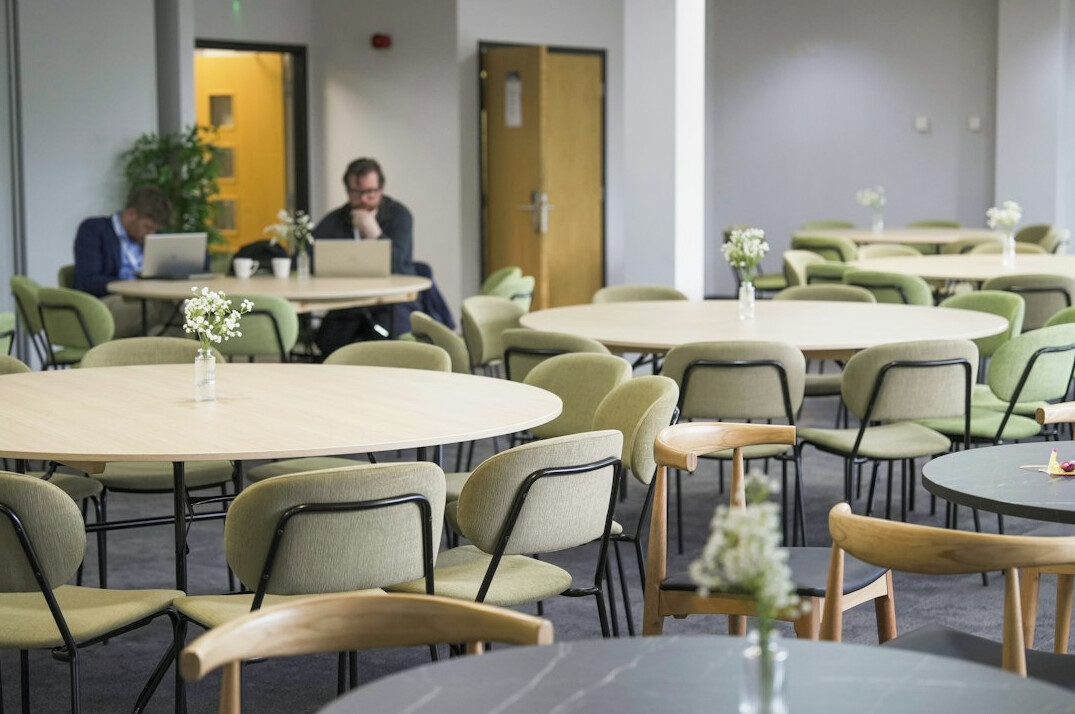 Team collaborating during a meeting in a bright meeting room