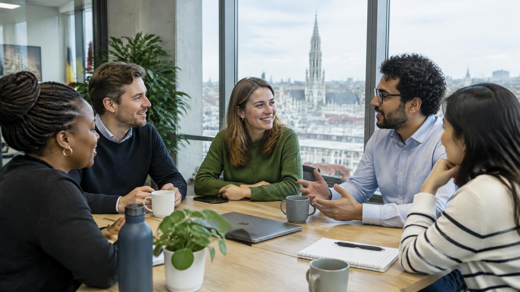 Colleagues having a friendly discussion in a modern Belgian office